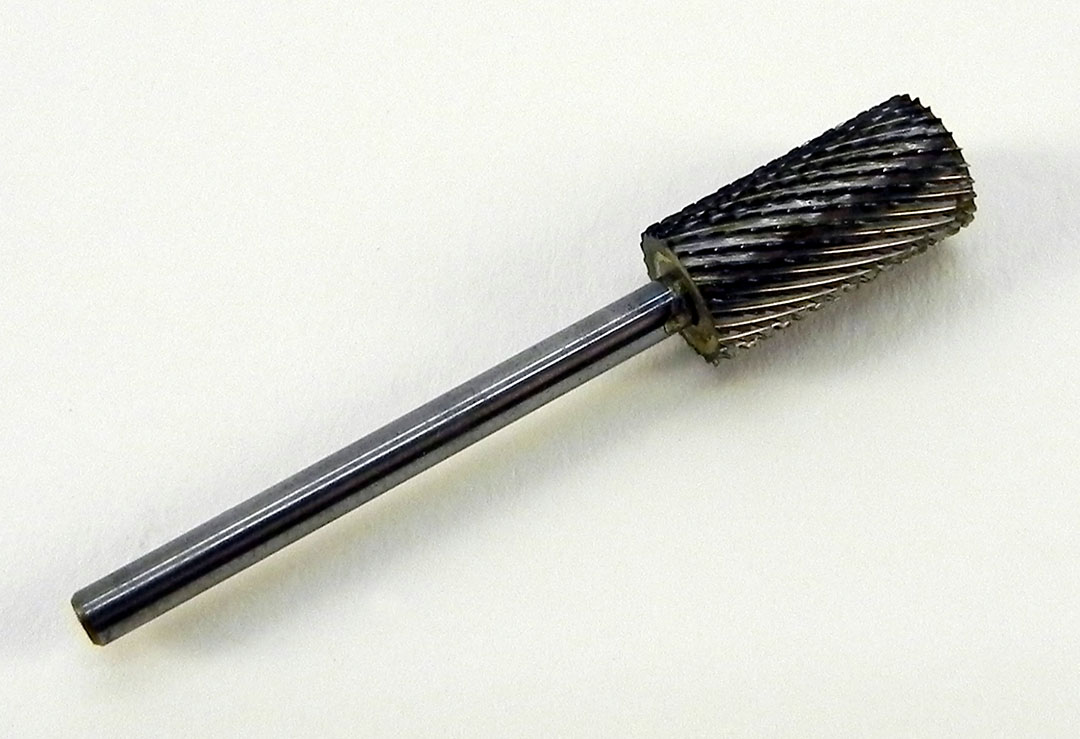 Grobkörniger Silber-Hartmetall-Bit in Form eines grossen Zylinders. Für das Feilen von Flächen, Kürzen der Nägel und die Bearbeitung von Modellage- und Gelmaterialien.